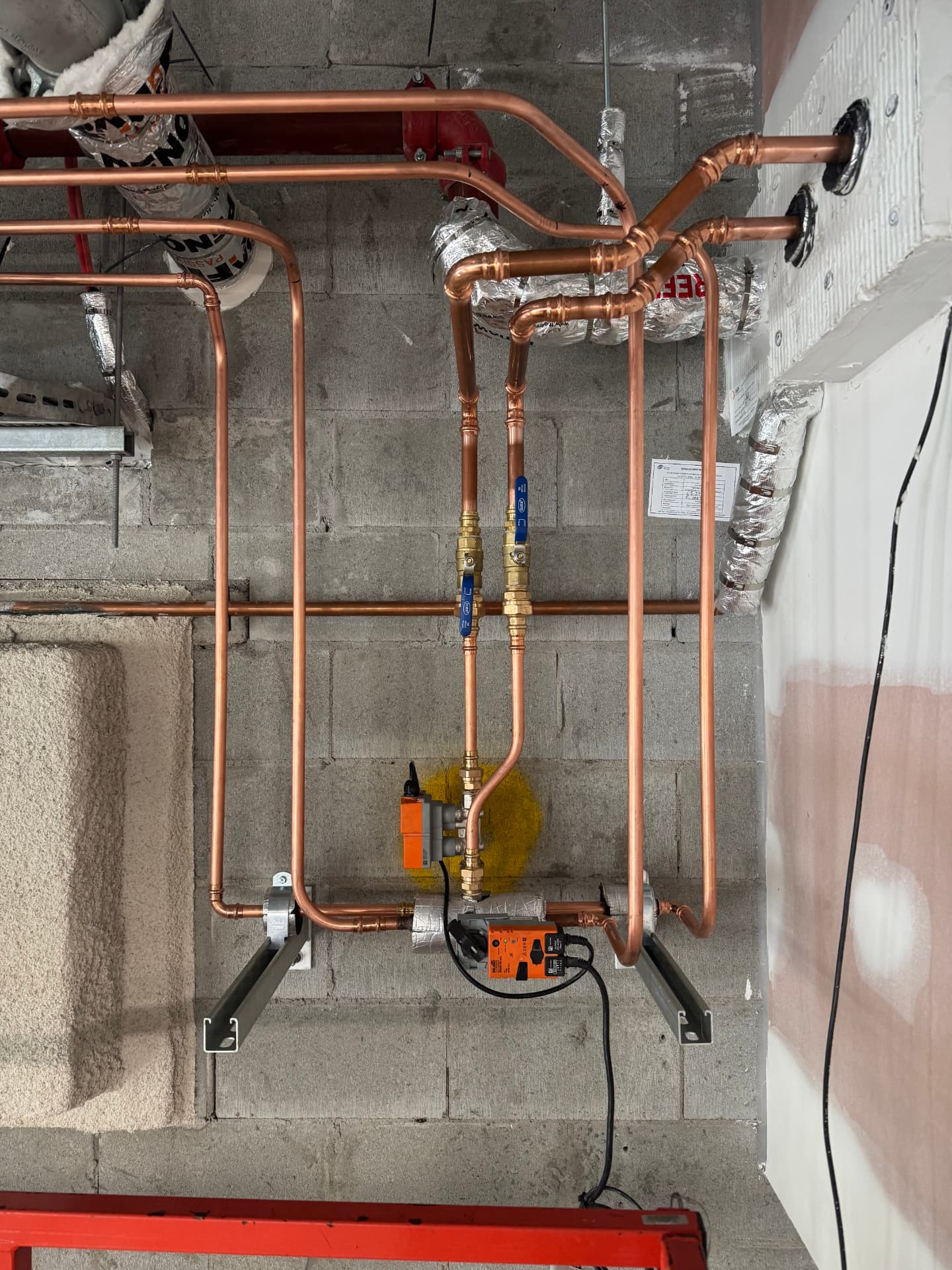 Copper mechanical services pipework, valves and actuators installed in a commercial plant room